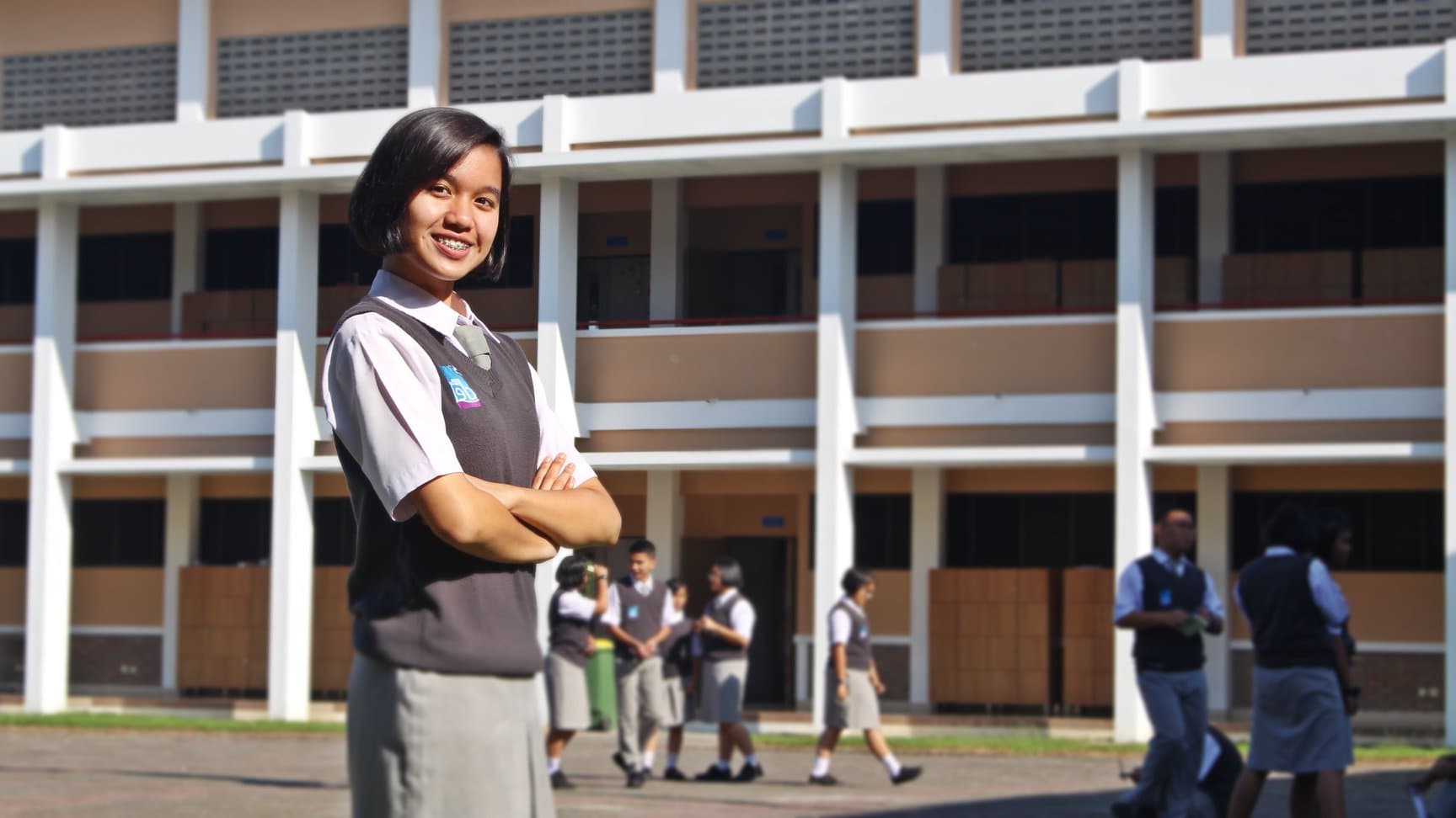 Student standing outside school building